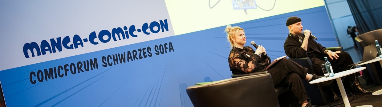 2 Personen auf der Bühne des Comicforum Schwarzes Sofa auf der Manga-Comic-Con 2025 2 Personen auf der Bühne des Comicforum Schwarzes Sofa auf der Manga-Comic-Con 2025
