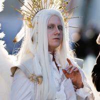 A person in an elaborate white fantasy costume at Manga Comic Con 2025