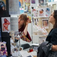 Artist booth with visitors in the New Artist Alley at Manga-Comic-Con 2025