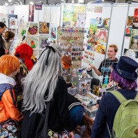 Artist booth with visitors in the New Artist Alley at Manga-Comic-Con 2025