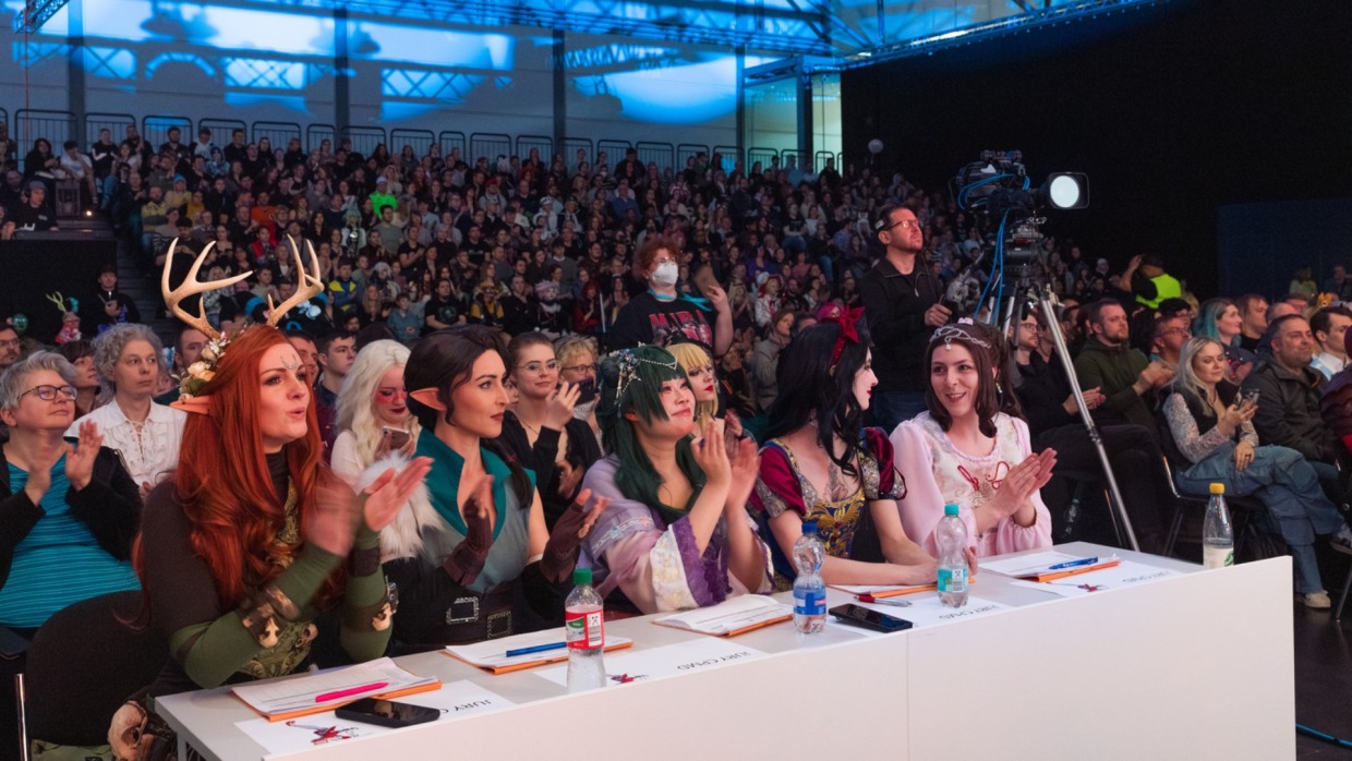 Die 5 Jurymitglieder der Cosplay Meisterschaft Deutschland 2026 sitzen klatschend vor dem Publikum auf der Manga Comic Con