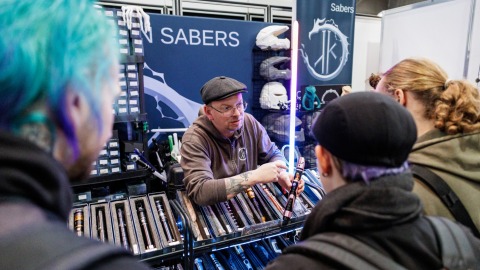 Exhibitor showing his product to visitors at his booth at Manga Comic Con 2026